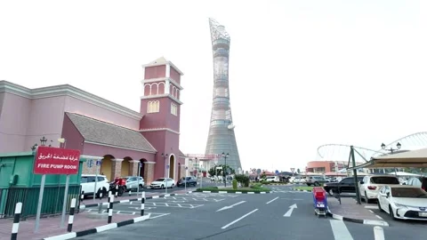 A view of the iconic Torch Doha hotel tower rising above the Villaggio Mall Stock Footage 336753587