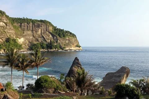 View of the idyllic Indonesian coast of Java Island with majestic mountains.. Stock Photos