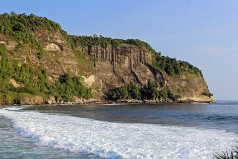 View of the idyllic Indonesian coast of Java Island with majestic mountains.. Stock Photos
