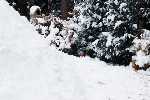 View of an igloo in a winter landscape and boy playing Stock Photos