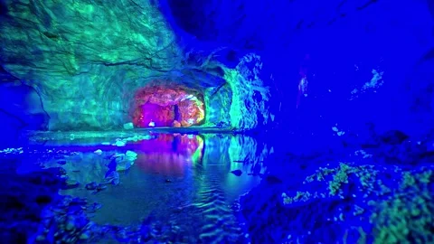 View of illuminated cave interior with colorful reflections, Norway. 库存影片 340639639