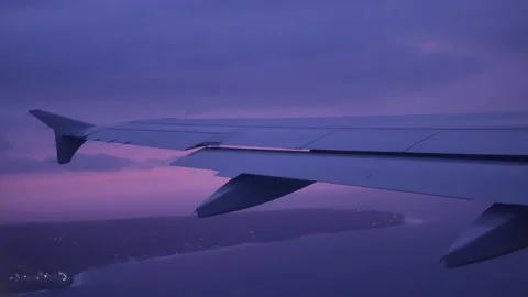 View from illuminator on airplane wing over the water at sunset - 4K, Gaining Stock Footage 183317612