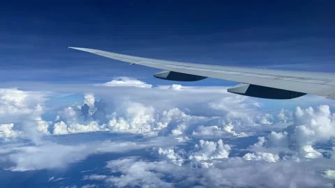 View from the illuminator of the big plane to the ocean and clouds. Stock Footage 163563055