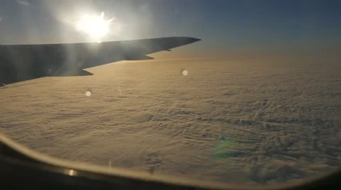View from the illuminator of a plane flying over the cloud cover. View to wing Stock Footage 62593750