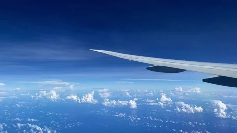 View from the illuminator to wing of the airplane to the ocean and clouds. Stock Footage 163370200