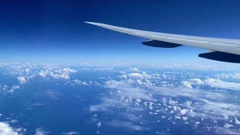View from the illuminator to wing of the airplane to the ocean and clouds. Stock Footage 163904801