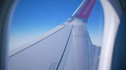 View from the illuminator to wing of the plane Stock Footage 100066067