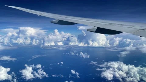View from the illuminator to wing of the plane to the ocean and clouds. Stock Footage 163317394