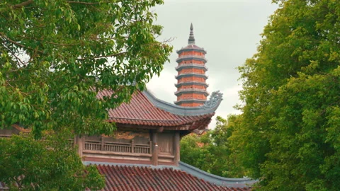 View of the imposing Bao Thap stupa at Bai Dinh pagoda amidst lush vegetation Video stock 331033329