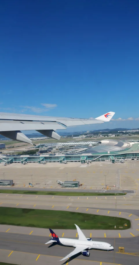 View of Incheon terminal from window of recently lifted off passenger plane Stock Footage 297053155