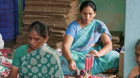 A view of Indian female workers packing and labelling incense stick bundles Stock Footage 241653575