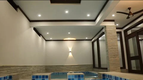 View Of Indoor Swimming Pool Space In Luxury Home With Blue White Tiling. Stock Footage 153216484