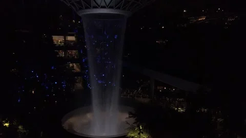 View of indoor vortex waterfall with light up decoration at The Jewel Chang.. Stock Footage 322116018