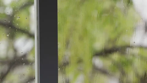 View from indoors on window with rain drops on its glass during cold winter day Vidéo 149914699