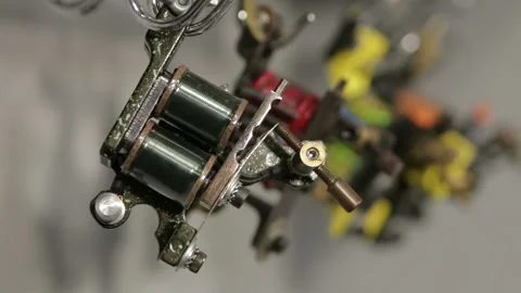 View on Induction tattoo machines on stand, running focus, macro Stock Footage 102811858