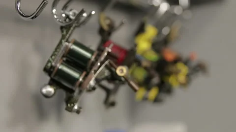 View on Induction tattoo machines on stand, running focus, macro Stock Footage 102812617