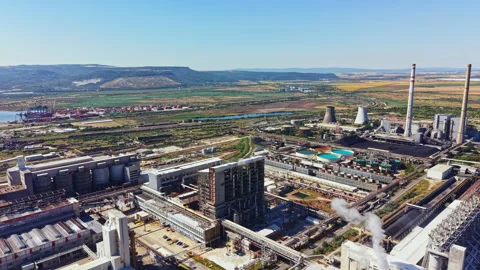 View of an industrial complex and surrounding landscape with smoke stacks and Stock Footage 341102468