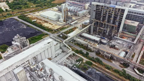 View of industrial complex showing multiple buildings, pipes, and machinery in Stock Footage 341586586