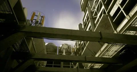 View of industrial equipment and structures from below in urban environment イラスト素材