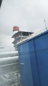 A view of industrial structures with a focus on a large platform and suppor.. Stock Photos