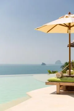 View from infinity edge pool with parasol to sea Stock Photos
