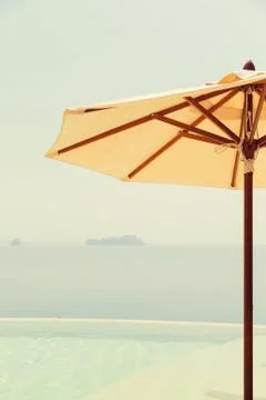 View from infinity edge pool with parasol to sea Stock Photos
