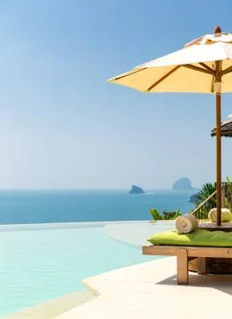 View from infinity edge pool with parasol to sea Stock Photos