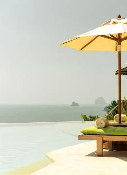 View from infinity edge pool with parasol to sea Stock Photos