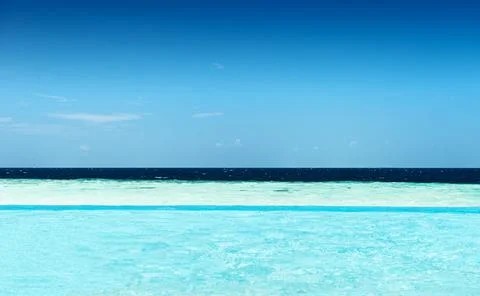 View from a infinity pool on the ocean with different shades of blue Stock Photos
