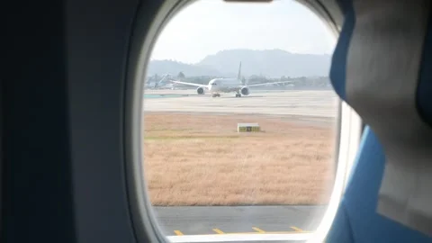 View inside airplane aircraft through plane window with view of airport's a.. Stock Footage 317220925