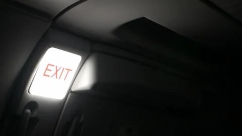 View inside airplane cabin to the emergency exit door with light signal for.. Видео 339574189