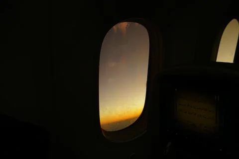 View from inside airplane to outside wing engine during dawn. Sun ray reflect Stock Photos