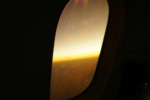 View from inside airplane to outside wing engine during dawn. Sun ray reflect Stock Photos