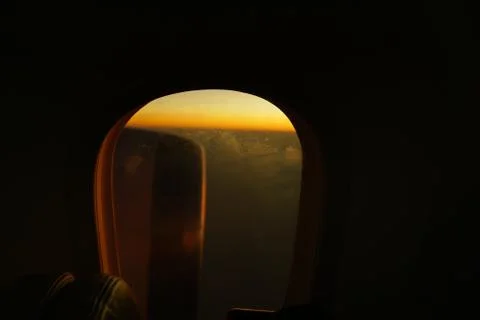 View from inside airplane to outside wing engine during dawn. Sun ray reflect Stock Photos
