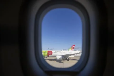 View from inside airplane window to TAP - Air Portugal in Lisbon Airport Stock Photos