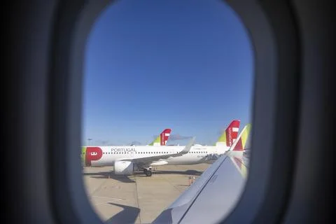 View from inside airplane window to TAP - Air Portugal, Lisbon Airport. Stock Photos