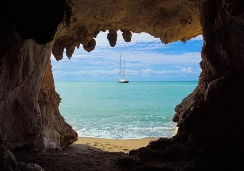 View from inside of big cave to the beach and blue sea. Mediterranean coast Stock Photos