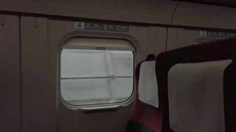 View from inside bullet train cabin with passenger seat and train's window .. Stock Footage 337929287