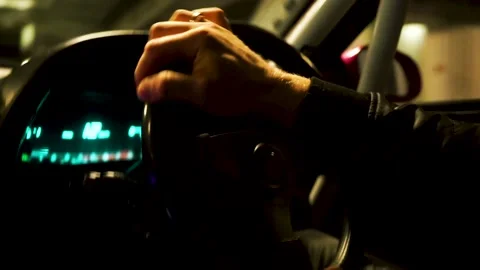 View inside of a car and the driving man. Footage. Close up of driver hands on 動画素材 133959940