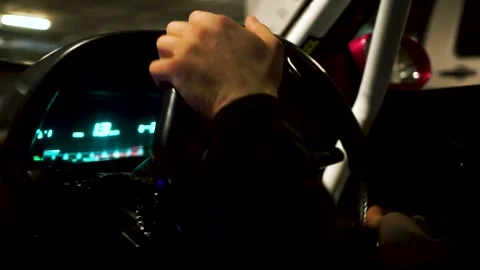 View inside of a car and the driving man. Footage. Close up of driver hands on Vidéo 133960093