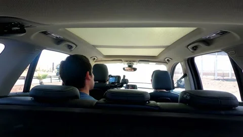 View inside a car from behind of three friends going on a highway trip on a 스톡 동영상 155774870