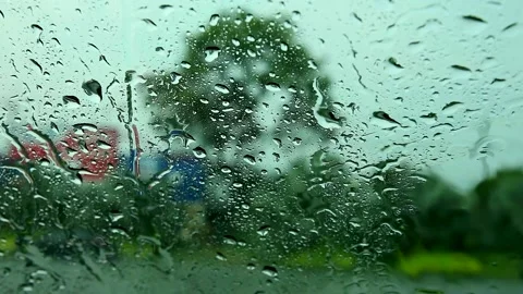 View inside car, driver parking car beside road because rain drop heavy Stock Footage 135799352