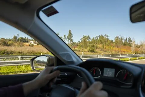 View from inside a car with driver, towards the road. Stock Photos