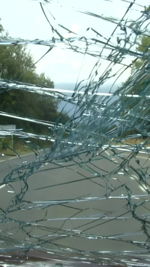 A view from the inside of a car driving on a road with a very cracked winds.. Stock Footage 306139970