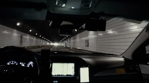 View from inside car driving through tunnel. Driver going inside dark tunnel. Stock Footage