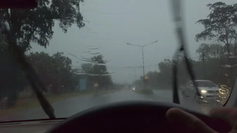 A view from inside a car driving on a wet road during heavy rain. The windshield Stock Footage 323380789
