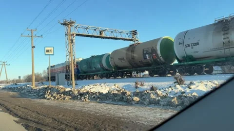 A view from inside a car of a freight train with tank cars moving along Stock Footage 328623603