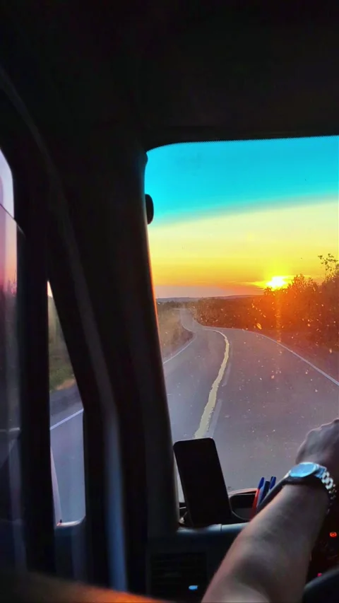View from inside car on hilly road. Beautiful sunset from the car window. Video stock 289709441