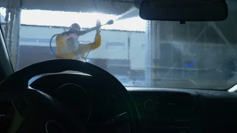 View from inside the car. a man washing a car at a car wash Stock-Footage 146180626