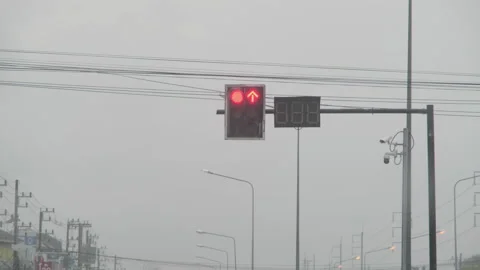 View from inside car parked on road waiting for traffic light turn green in rain Stock Footage 174086771